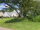 Charming home exterior showcasing well-maintained landscaping and a beautiful, mature tree in the front yard at 333 Etoawha Vly, Woodstock, GA 30189