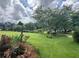 Beautiful front yard featuring a lush lawn, mature trees, and colorful flower beds, offering great curb appeal at 333 Etoawha Vly, Woodstock, GA 30189