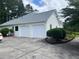 Spacious two-car garage with a white exterior and a well-maintained driveway, adding convenience and curb appeal at 333 Etoawha Vly, Woodstock, GA 30189