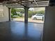 View of two-car garage with open doors, showing ample space and neighborhood view at 333 Etoawha Vly, Woodstock, GA 30189