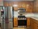 A well-equipped kitchen featuring stainless steel appliances and granite countertops at 333 Etoawha Vly, Woodstock, GA 30189
