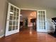 Open view of a living room with hardwood floors, natural light, and fireplace at 333 Etoawha Vly, Woodstock, GA 30189