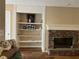 Living room featuring a stone fireplace and built-in shelving at 333 Etoawha Vly, Woodstock, GA 30189
