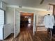 Open view of a living room with hardwood floors, natural light, and clothing rack at 333 Etoawha Vly, Woodstock, GA 30189