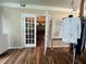 Open view of a living room with hardwood floors, natural light, and clothing rack at 333 Etoawha Vly, Woodstock, GA 30189