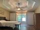 A well-lit main bedroom featuring hardwood floors and a tray ceiling at 333 Etoawha Vly, Woodstock, GA 30189