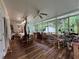 Bright sun room with hardwood floors and large windows providing views of the wooded backyard at 333 Etoawha Vly, Woodstock, GA 30189