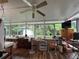 Bright sun room with hardwood floors and large windows providing views of the wooded backyard at 333 Etoawha Vly, Woodstock, GA 30189