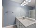 Bright bathroom featuring a quartz countertop, vanity, and large framed mirror at 3737 Town Square Nw Cir # 6, Kennesaw, GA 30144