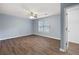 Neutral bedroom features hardwood floors, a ceiling fan, and a walk-in closet at 3737 Town Square Nw Cir # 6, Kennesaw, GA 30144