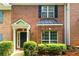 Two-story brick townhome with black accents and mature landscaping at 3737 Town Square Nw Cir # 6, Kennesaw, GA 30144