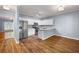 Bright kitchen featuring white cabinets, stainless steel appliances, and hardwood floors at 3737 Town Square Nw Cir # 6, Kennesaw, GA 30144