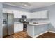 White kitchen cabinets, stainless steel appliances, and granite countertops at 3737 Town Square Nw Cir # 6, Kennesaw, GA 30144