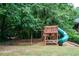 Community playground featuring a slide and swingset surrounded by lush greenery and open space at 3737 Town Square Nw Cir # 6, Kennesaw, GA 30144