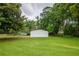 Spacious backyard featuring lush grass and a private wooded area; perfect for outdoor enjoyment at 5961 John St, Austell, GA 30106