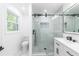 Bright bathroom features marble and tile finishes, a glass shower, and modern toilet and vanity at 5961 John St, Austell, GA 30106
