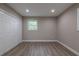 Spacious bedroom features new floors, a window, recessed lights, and a closet with paneled doors at 5961 John St, Austell, GA 30106