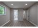 Large bedroom with new floors featuring access to a full bathroom and other rooms at 5961 John St, Austell, GA 30106