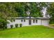 Charming single-story home with white painted brick and well-manicured lawn at 5961 John St, Austell, GA 30106