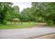 Neighborhood park featuring playground and picnic area surrounded by lush trees at 5961 John St, Austell, GA 30106