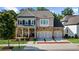 Charming two-story home boasts stone accents, a covered porch, and a convenient two-car garage at 10140 Grandview Sq, Duluth, GA 30097