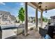 Spacious front porch with stone columns, outdoor seating, and a view of the neighborhood at 10140 Grandview Sq, Duluth, GA 30097