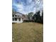 Spacious backyard featuring the back of the house, sunroom, fencing and large grassy area at 1046 Sans Souci Way, Clarkston, GA 30021
