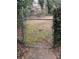 Metal chain link fence gate on a property surrounded by plants and undergrowth at 1046 Sans Souci Way, Clarkston, GA 30021