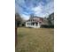 Spacious backyard featuring the back of the house, sunroom and large grassy area at 1046 Sans Souci Way, Clarkston, GA 30021