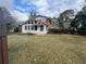 Spacious backyard featuring the back of the house, sunroom and large grassy area at 1046 Sans Souci Way, Clarkston, GA 30021