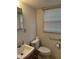 This is a cozy bathroom with a single sink and a toilet next to the window at 1046 Sans Souci Way, Clarkston, GA 30021