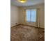 Comfortable bedroom featuring carpet flooring and a bright window for ample lighting at 1046 Sans Souci Way, Clarkston, GA 30021