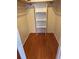 Walk-in closet with wooden floors, open shelving and clothes rods at 1046 Sans Souci Way, Clarkston, GA 30021
