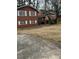 This is a full exterior view showing the house, lawn, and driveway at 1046 Sans Souci Way, Clarkston, GA 30021