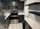 Modern kitchen with stainless steel appliances, dark cabinetry, and bright countertops at 1683 Briarcliff Ne Rd # 4, Atlanta, GA 30306