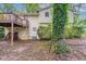 Backyard view with a deck, stairs, and mature trees, offering a serene outdoor space at 2047 Cliffton Ter, Snellville, GA 30039