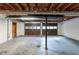 Unfinished basement featuring concrete floors, support beams, and access to a garage at 2047 Cliffton Ter, Snellville, GA 30039