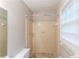 Bathroom showcasing a shower-tub combo with tiled walls and a window for natural light at 2047 Cliffton Ter, Snellville, GA 30039