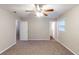 Inviting bedroom featuring neutral walls, carpet floors, and a ceiling fan with lights at 2047 Cliffton Ter, Snellville, GA 30039