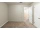 Empty bedroom showcasing neutral walls, carpet floors, and a closet with an open door at 2047 Cliffton Ter, Snellville, GA 30039