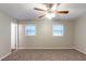 Comfortable bedroom featuring neutral walls, carpet floors, and a ceiling fan with lights at 2047 Cliffton Ter, Snellville, GA 30039