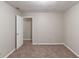 Empty bedroom showcasing neutral walls and carpet floors with an open door at 2047 Cliffton Ter, Snellville, GA 30039