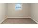 Empty bedroom showcasing neutral walls, carpet floors, and a window for natural light at 2047 Cliffton Ter, Snellville, GA 30039