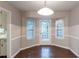 Bright dining area featuring hardwood floors, a pendant light, and natural light from multiple windows at 2047 Cliffton Ter, Snellville, GA 30039
