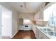 Bright kitchen featuring white cabinetry, white appliances, and modern countertops at 2047 Cliffton Ter, Snellville, GA 30039