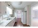 Spacious kitchen with white cabinets, stainless steel sink, and hardwood floors at 2047 Cliffton Ter, Snellville, GA 30039