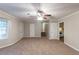 Spacious living room with neutral walls, carpet floors, and a ceiling fan with lights at 2047 Cliffton Ter, Snellville, GA 30039