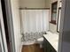 Cozy bathroom with decorative shower curtain and wood-look floors at 267 Toweridge Sw Dr, Marietta, GA 30064