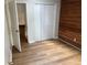 Bedroom includes wood-look flooring, wood accent wall and closet at 267 Toweridge Sw Dr, Marietta, GA 30064