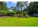 Expansive backyard with lush green lawn and mature landscaping offers a private outdoor retreat for relaxation and recreation at 3415 Habersham Nw Rd, Atlanta, GA 30305